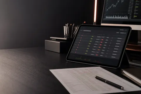 Macroeconomic research workspace with a market calendar on a tablet